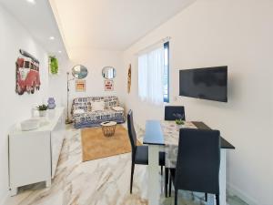 a dining room and living room with a table at Mermaid Beach in Roquebrune-Cap-Martin