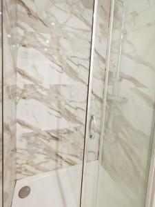 a shower with a white marble wall at Mermaid Beach in Roquebrune-Cap-Martin +9 photos