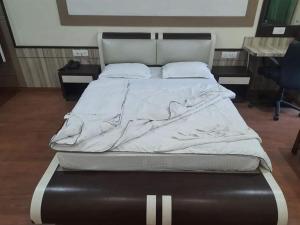 a large bed in a room with a bedskirts at Hotel Haven Intercontinental in Agartala