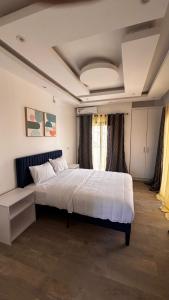 a bedroom with a large white bed in a room at Havre de paix in Dakar