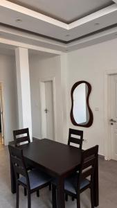 a dining room table with chairs and a mirror at Havre de paix in Dakar
