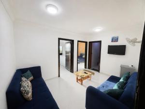 a living room with a blue couch and a table at Nice Apartment with Sea View in Aqaba