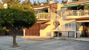 a yellow building with a tree in front of it at Arithea Hidden Seaside Heritage 2BR Suite in Paphos