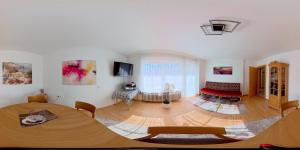 a living room with a table and a couch at Gästehaus Sophie in Trittenheim