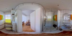 a large bathroom with a shower and a sink at Gästehaus Sophie in Trittenheim +7 photos