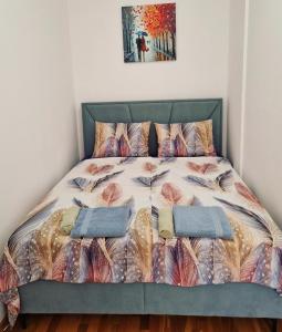 a bed in a bedroom with two pillows on it at Avenue Apartment Sarajevo in Sarajevo