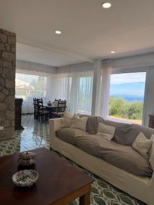 a living room with a couch and a table at Villa Maria Marcella in Porto Santo Stefano