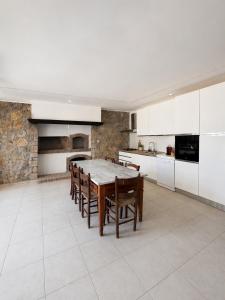a large kitchen with a table and chairs in it at Villa Maria Marcella in Porto Santo Stefano