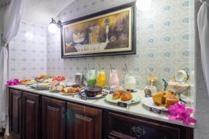 a breakfast table with pastries and other foods on it at Pousada Estalagem de Brotas in Brotas