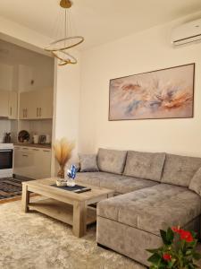 a living room with a couch and a coffee table at Avenue Apartment Sarajevo in Sarajevo