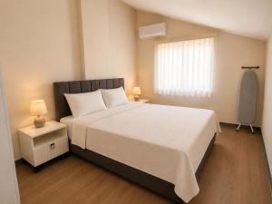a bedroom with a large white bed and a window at Berm Suites in Antalya +58 photos