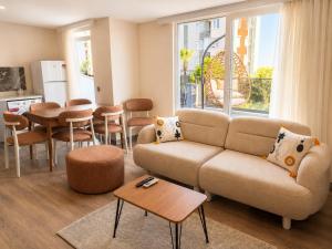 a living room with a couch and a table at Berm Suites in Antalya
