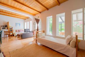 a bedroom with a bed and a living room at Quinta dos Cochichos - Country Houses in Olhão +243 photos