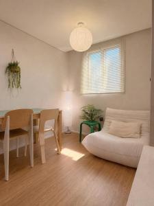 a living room with a table and a white couch at 무무 mumu in Seoul