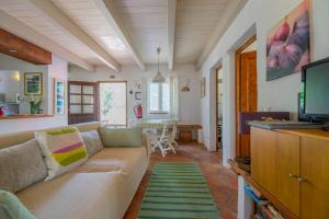a living room with a couch and a table at Quinta dos Cochichos - Country Houses in Olhão