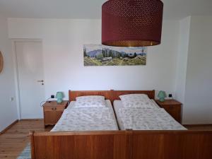 a bedroom with two beds and a painting on the wall at Ferienhaus Anni in Warngau