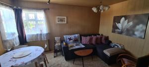 a living room with a couch and a table at Grund in Ólafsvík in Ólafsvík