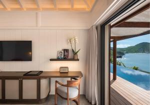 a home office with a desk and a view of the ocean at Hotel Christopher Saint Barth in Pointe Milou