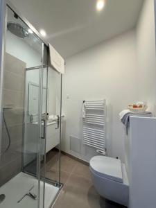 a bathroom with a toilet and a glass shower at Laulique in Les Lilas