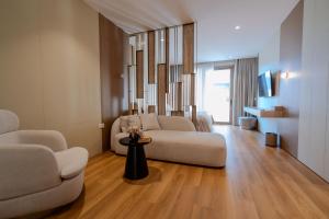 a living room with a couch and a chair at Flower Hotels & Resorts in Golem