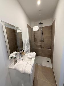 a bathroom with a sink and a shower at Laulique in Les Lilas +4 photos