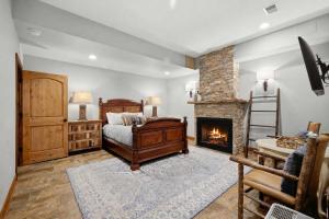 a bedroom with a bed and a fireplace at The Moose House by Juniper Holiday + Home in New Buffalo