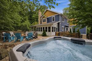 a hot tub in the backyard of a house at The Moose House by Juniper Holiday + Home in New Buffalo