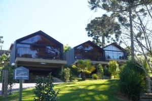 a house with two balconies on top of a yard at Cappio Pousada e Lazer in Bento Gonçalves