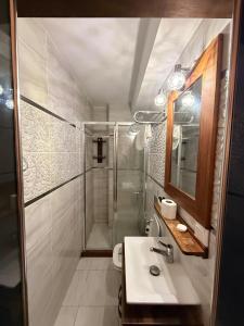 a bathroom with a shower and a sink at Ceren pansiyon in Seferihisar +20 photos