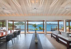 a dining room with a view of the ocean at Hotel Christopher Saint Barth in Pointe Milou