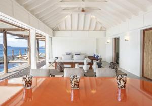 a dining room with a table and chairs at Hotel Christopher Saint Barth in Pointe Milou