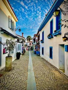 a cobblestone street in a town with buildings at Ceren pansiyon in Seferihisar