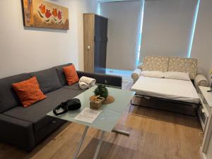 a living room with a couch and a table at A&R Isla de la Palma in San Sebastián de los Reyes +10 photos