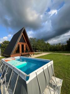a swimming pool in front of a house at Aba Ula in Martvili