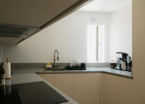 a kitchen with a sink and a window at Outsite Ericeira - Boavista in Ericeira