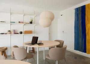 a room with a table with a laptop on it at Outsite Ericeira - Boavista in Ericeira