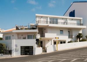 a white building on the side of a street at Outsite Ericeira - Boavista in Ericeira