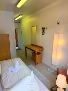 a bedroom with a bed and a desk with a mirror at Weaky what you want in Ugine