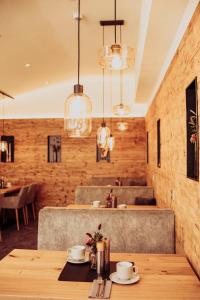 a dining room with a wooden table and chandeliers at Pension Sommer in Waldsassen
