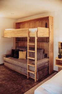 a bunk bed with a couch in a room at Pension Sommer in Waldsassen