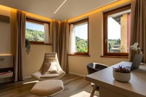 an office with a desk and chairs and windows at Casa Sgubin in Cormòns