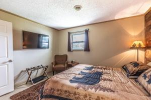 a bedroom with a large bed and a chair at Mountain Forest Manor in Hiawassee +11 photos