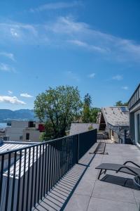 a balcony with a view of the water at DAS ANTON - Penthouse mit Seeblick und kostenloser Garage in Gmunden +30 photos