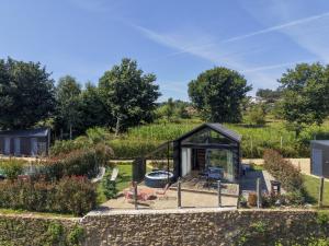 a greenhouse in a garden with a stone wall at Bruval Eco Retreat in Sandim +111 photos