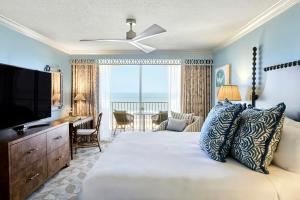 a bedroom with a bed with a television and a desk at Omni Amelia Island Resort & Spa in Amelia Island