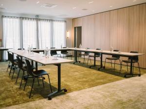 a large conference room with long tables and chairs at Mercure Quimper Kerlic in Quimper +122 photos