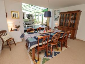 a dining room with a table and chairs at The Garden Rooms in Narberth