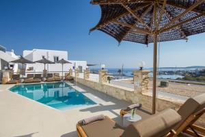 Eine Villa mit Swimmingpool, Liegestühlen und Sonnenschirm in der Unterkunft Paliomylos Spa Hotel in Naoussa