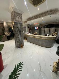 a large lobby with a counter in a store at Hotel Mounia in Fez