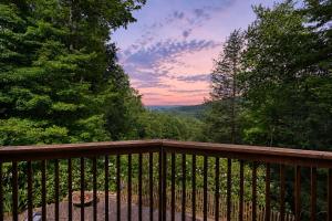 a wooden deck with a view of the forest at Charming 4BR Cabin - HOT TUB - Mountain View in Hoyes Run
